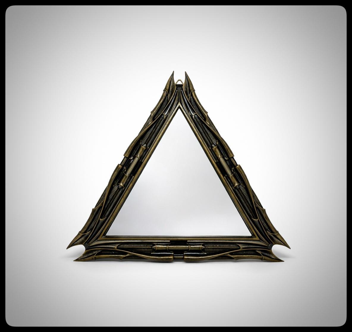 Inspired by H.R. Giger -Mirror Triangular 1983 H 11.02" (28 cm/280 mm) W 12.99" (33 cm/330 mm)